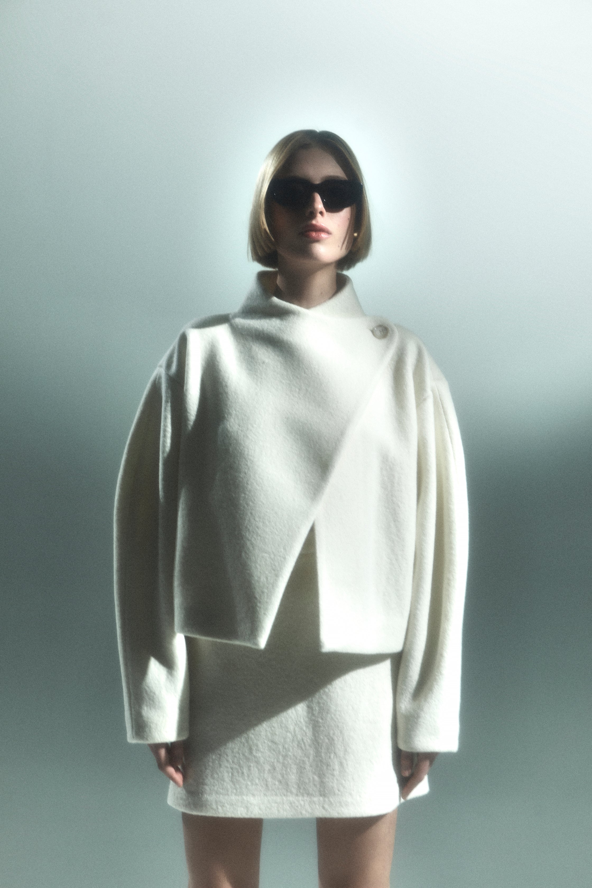 Rhúne AW24 campaign — sculptural white wool jacket and skirt