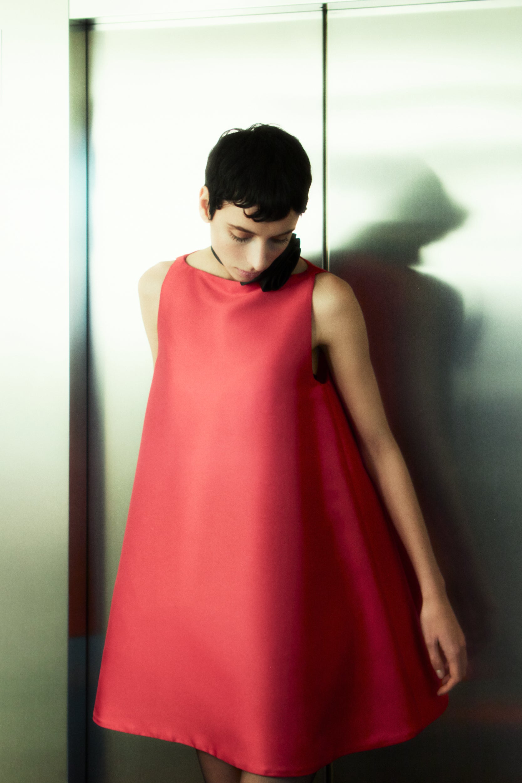 Rhúne AW25 Barbara Dress in red duchesse satin — sculptural A-line silhouette with minimalist elegance