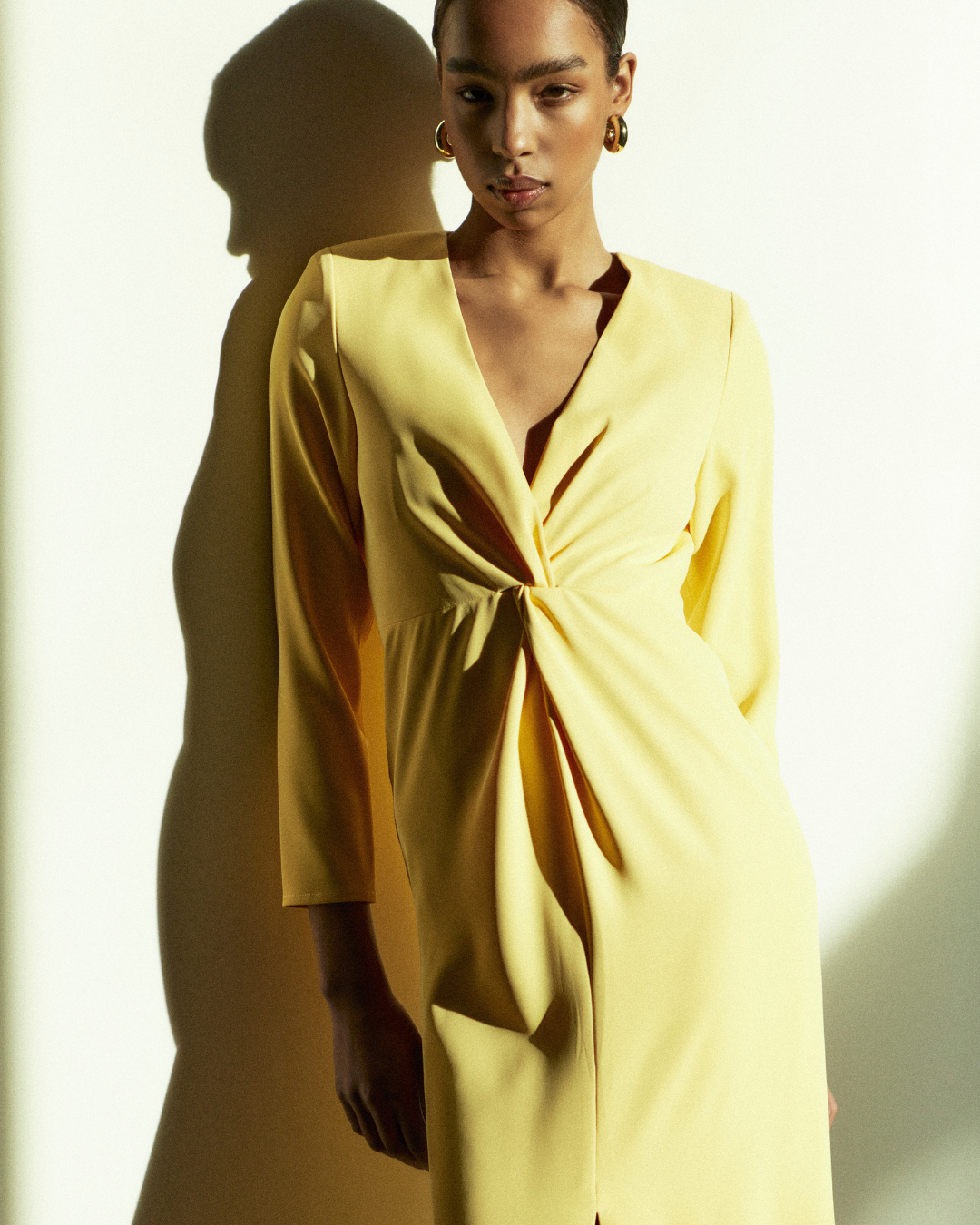 Rhúne SS25 Elisa Dress — luminous yellow draped silhouette capturing the essence of understated glamour