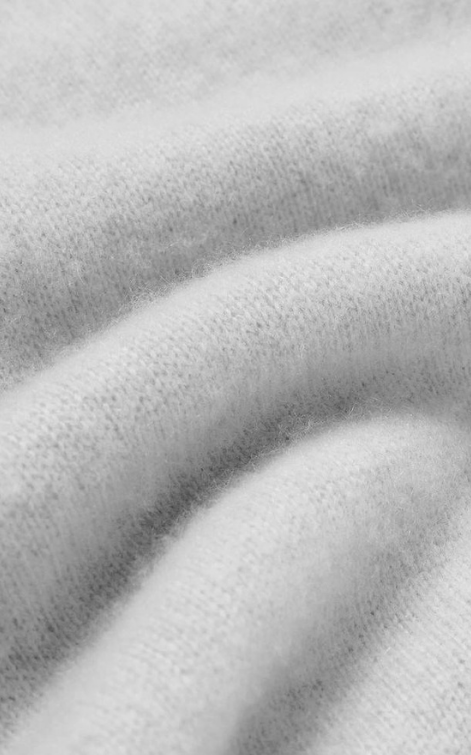Close-up of soft wool fabric showing delicate texture and refined craftsmanship — Rhúne atelier materials