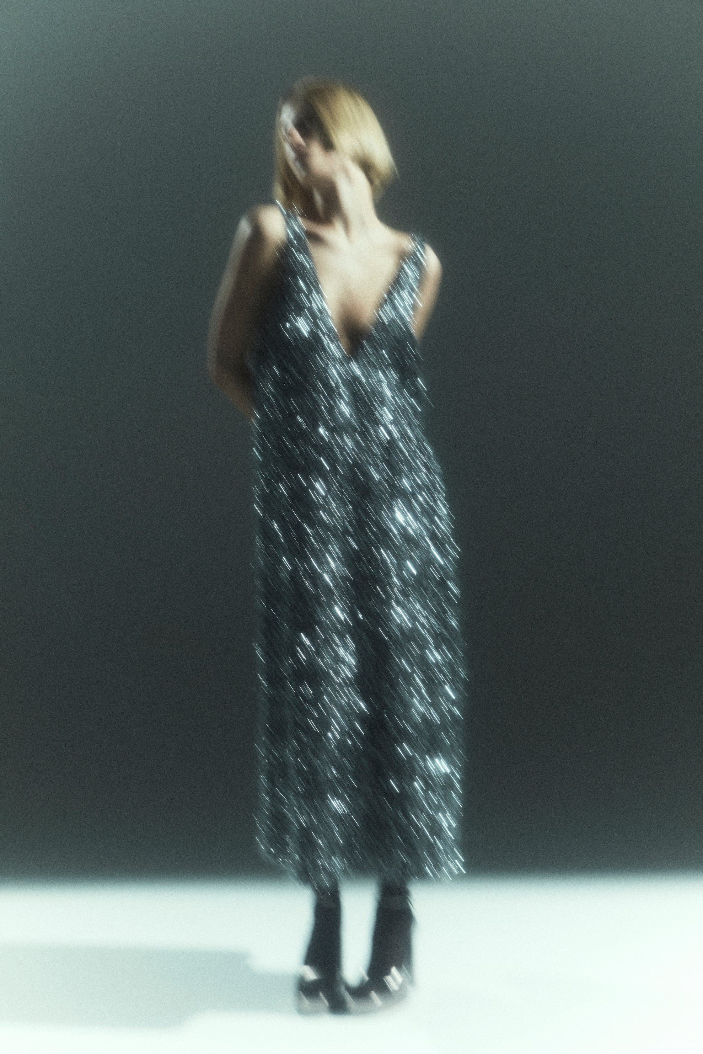 Rhúne Autumn Winter 2024 campaign — shimmering sequin dress captured in soft motion blur