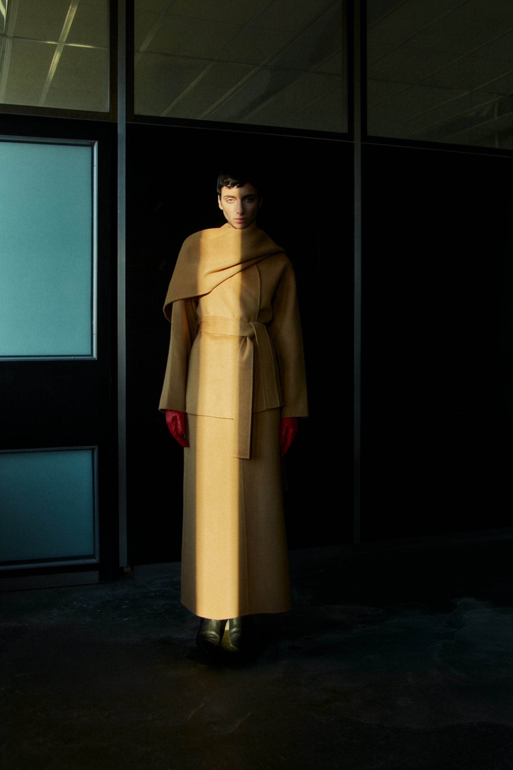 Rhúne AW25 campaign — camel double-face wool coat with sculptural silhouette
