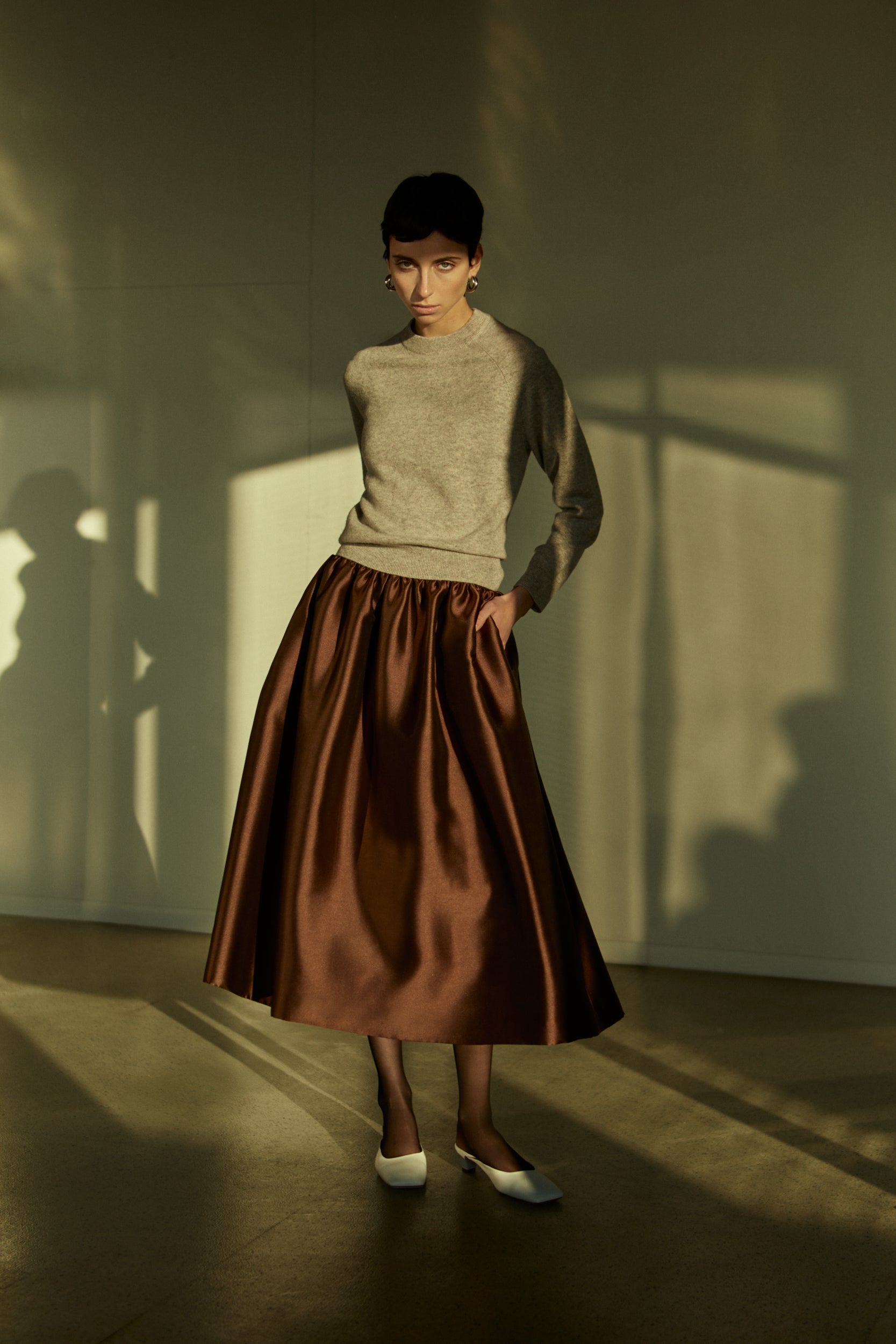 Rhúne AW25 Idris Knit in beige styled with Jade Skirt in brown satin