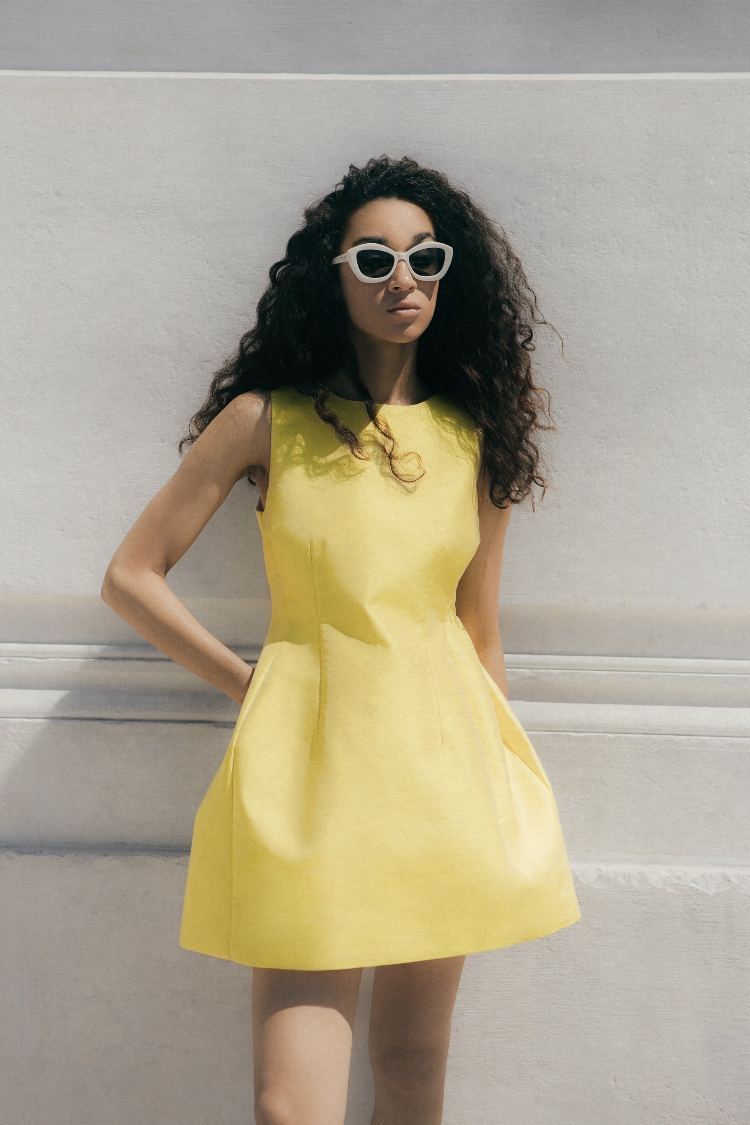 Rhúne SS24 April Dress — structured yellow silhouette captured in Venetian sunlight