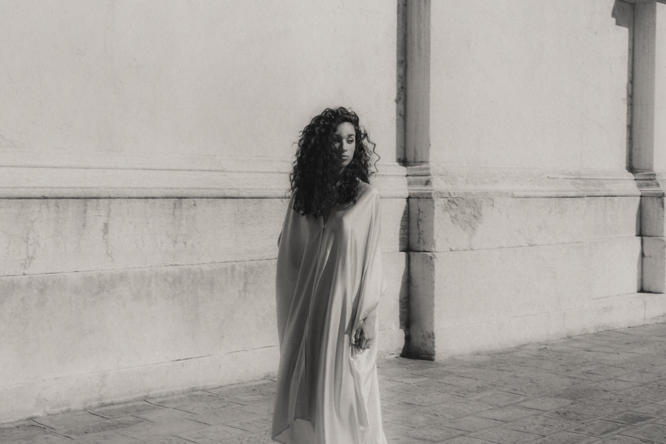 Rhúne Spring Summer 2024 campaign — timeless draped silhouette captured in soft monochrome tones